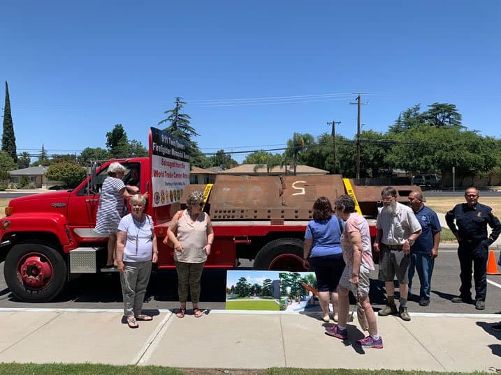 Community members viewing the memorial beam